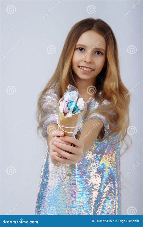 Beautiful Girl Smiles and Holds a Lolly in Her Hands. a Marshmallow ...