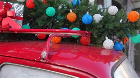 Little red car loaded up with festive holiday decorations and Christmas ...