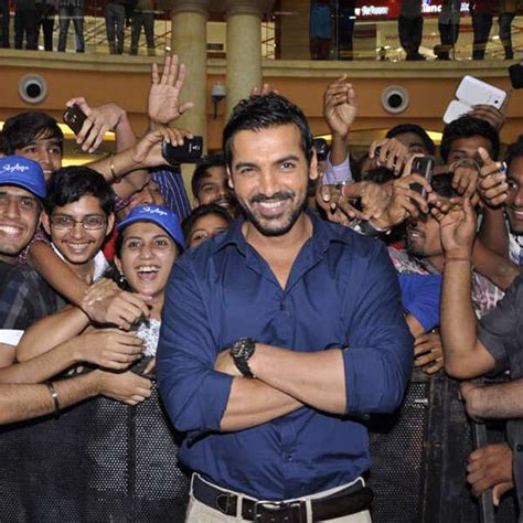 John Abraham smiles into the camera during the launch of new baggage ...