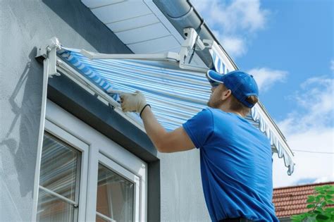A man installing a striped awning on a house | Premium AI-generated image