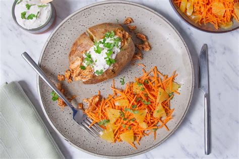 Baked potatoes with super quick pulled chicken and carrot salad