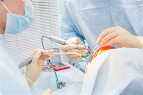 Dentist carrying out dental procedure on male patient, close-up