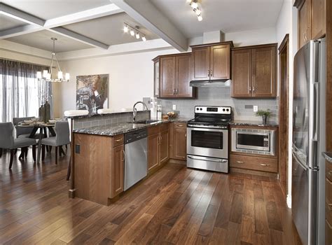 Gorgeous medium toned wood floors and cabinetry paired with sleek ...