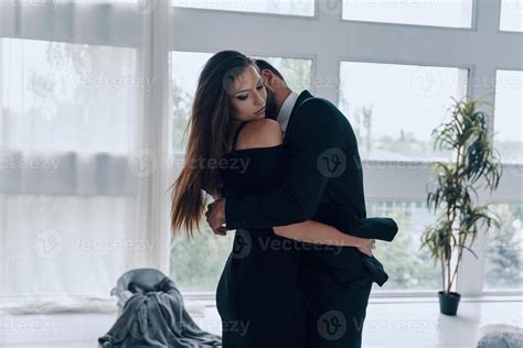 Gentle kiss. Beautiful young couple kissing and embracing while ...