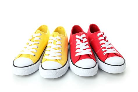 Premium Photo | Pair of red and yellow sneakers isolated on white ...