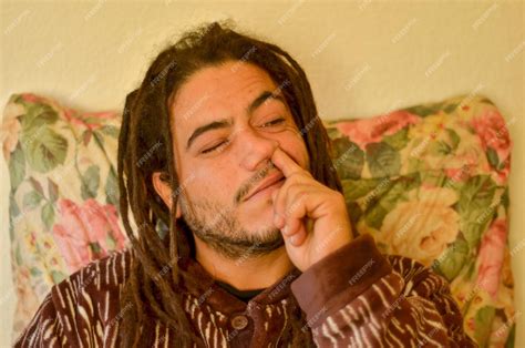 Premium Photo | Spanish man sitting on his colorful couch at home ...