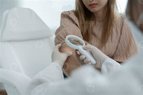 skin problem and beauty of asian girl. specialist of skin use magnifying glass look itchy skin ...