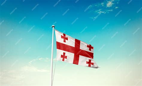 Premium Photo | Georgia flag waving in the beautiful sky