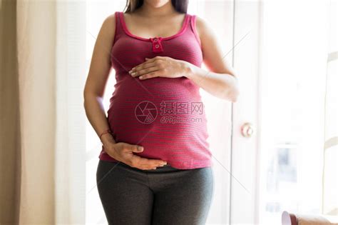 中产孕妇在家中抚摸肚子以感受胎儿运动高清图片下载-正版图片502919622-摄图网