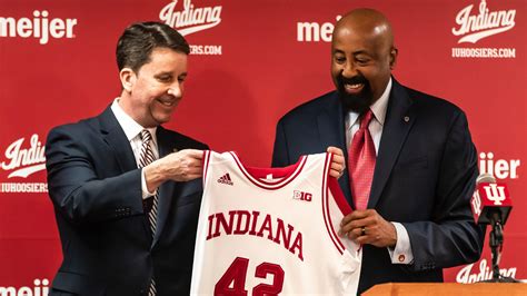 Indiana basketball coach Mike Woodson embraces Bob Knight, IU family