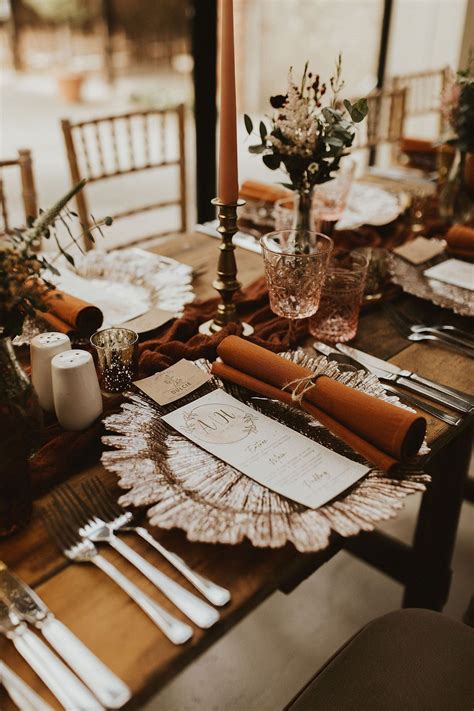 Rustic Wedding Table Place Setting with Rust Napkins and Gold Candlesticks