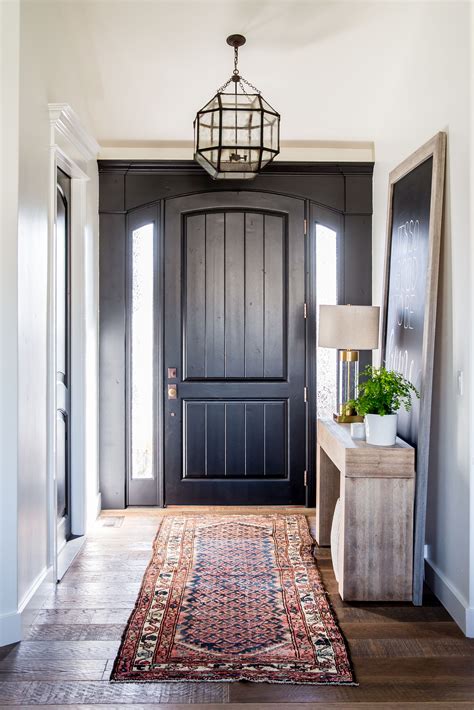 entryway with black front door and a kilim rug | Entry way design ...