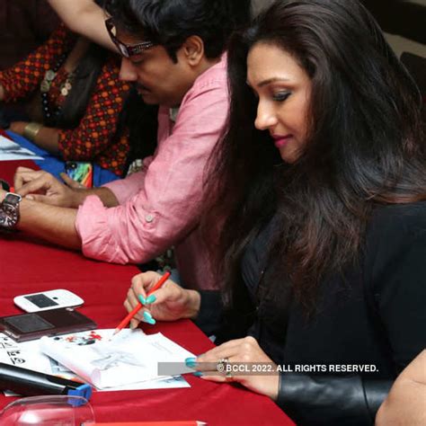 Rituparna Sengupta gives away her autographs during the trailer launch