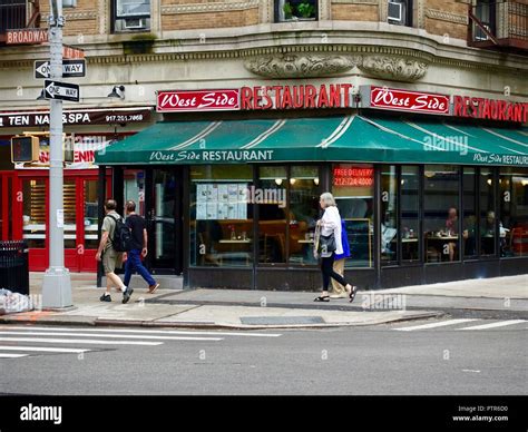 People walking past the West Side Restaurant while diners eat inside, Manhattan, New York, NY ...