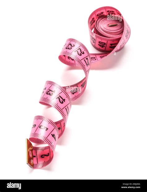 Pink measuring tape on white background Stock Photo - Alamy