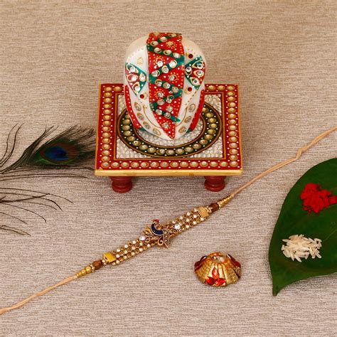 Designer Peacock Rakhi with Lord Ganesha on Kundan Studded Marble ...