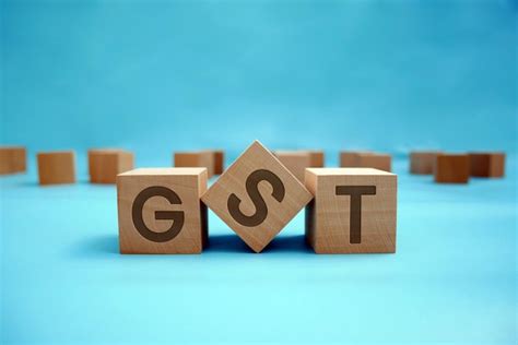 Gst on wooden surface on beautiful blue background with copy space ...