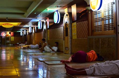People resting on mats in jjimjilbang