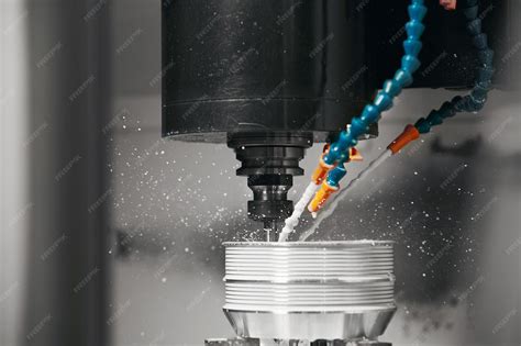Metalworking cnc machine drilling with coolant close up metal machine ...