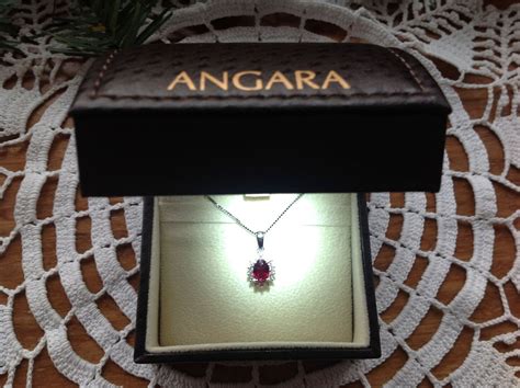 Oval Ruby Pendant with Floral Diamond Halo