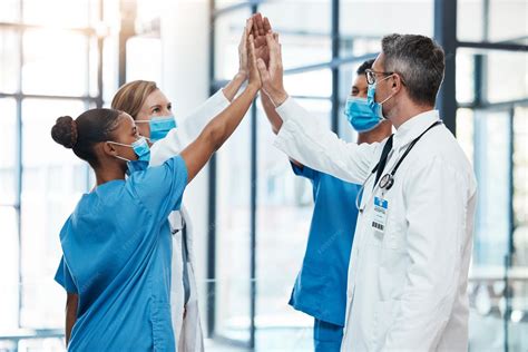 Premium Photo | Covid doctors and nurses high five for teamwork success collaboration and ...