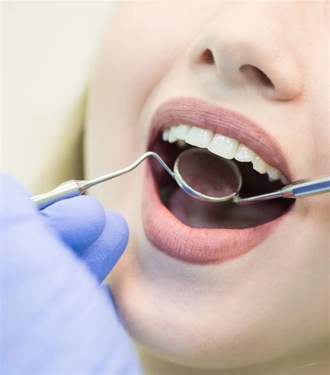 Close-up picture of young woman sitting in the dentist's chair with ...