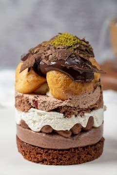 Layered profiteroles cake whipped cream chocolate and pistachio cake ...