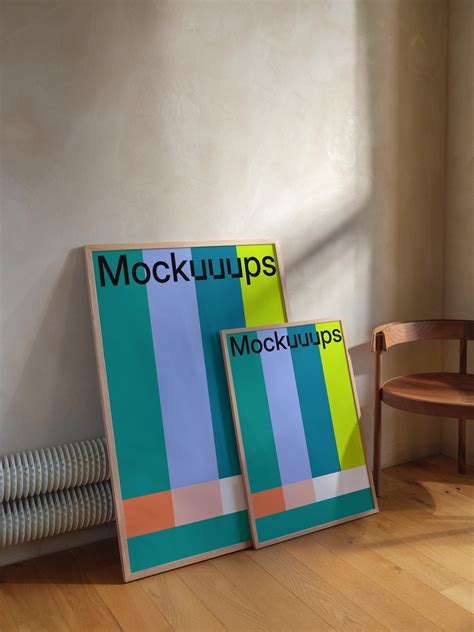 Framed poster mockup leaning against a wall with chair - Mockuuups Studio