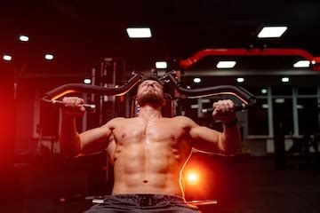 Strong athlete man with naked torso working out in the gym. handsome ...