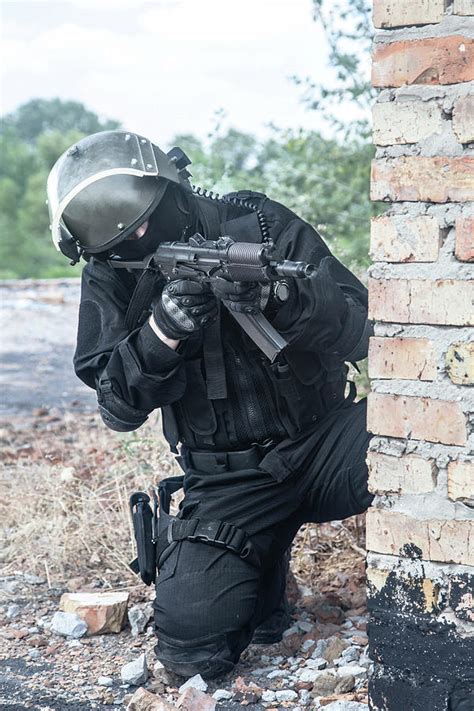 Spec ops soldier in black uniform and face mask with shotgun. Poster オリジナル