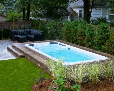 Hydropool Self Cleaning swim spa installed in ground with stone deck ...