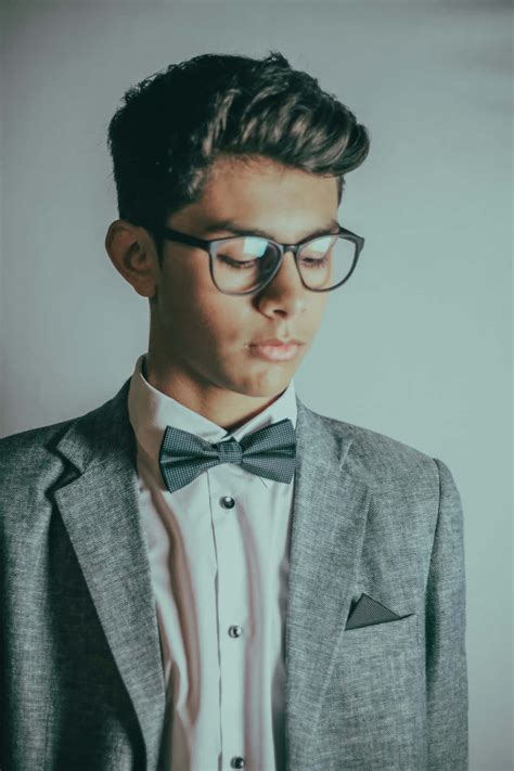 Download Stylish Teenagerin Suitand Bowtie Wallpaper | Wallpapers.com