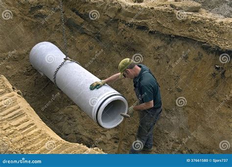 Worker Laying New Sewer Pipe in Slot in the Street Editorial Image ...