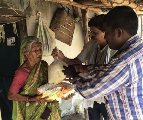 CMPDI officers distribute food material to the needy people