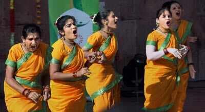 School girls perform during the flag hosting ceremony of CWG 2010 at ...