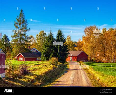 Country road with red barn and house Stock Photo - Alamy