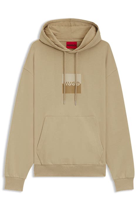 HUGO - Relaxed-fit hoodie in cotton terry with split logo - Beige