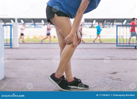 Asian Woman Leg Pain and Calf Muscle while Jogging in a Park Stock ...