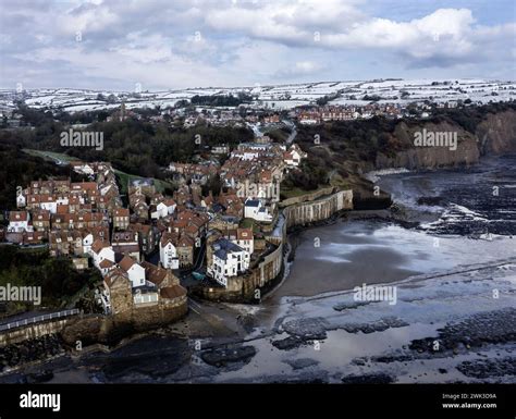 robin hoods bay north yorkshire in winter with snow on hills daytime ...