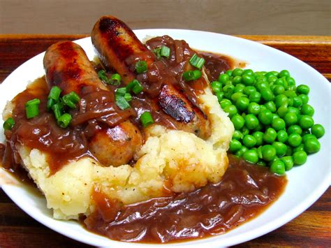 Sage sausages and onion gravy on rough mash with peas. : r/UK_Food