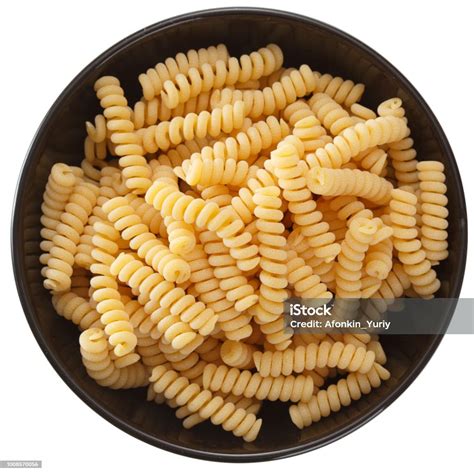 Curly Pasta In Black Round Clay Bowl Isolated On White Background Top ...