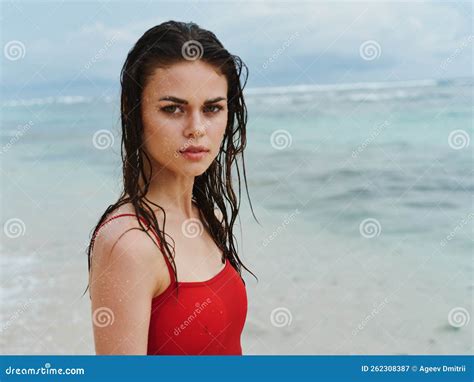 Beautiful Woman on the Beach by the Sea in a Red Swimsuit Stock Image ...