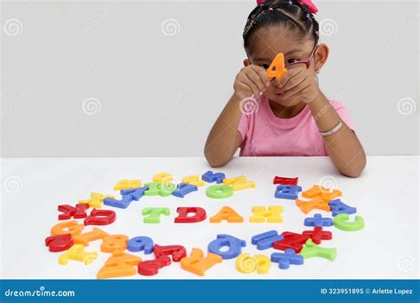 4 Year Old Latina Girl Plays with Letters Forms the Word TDAH Which ...