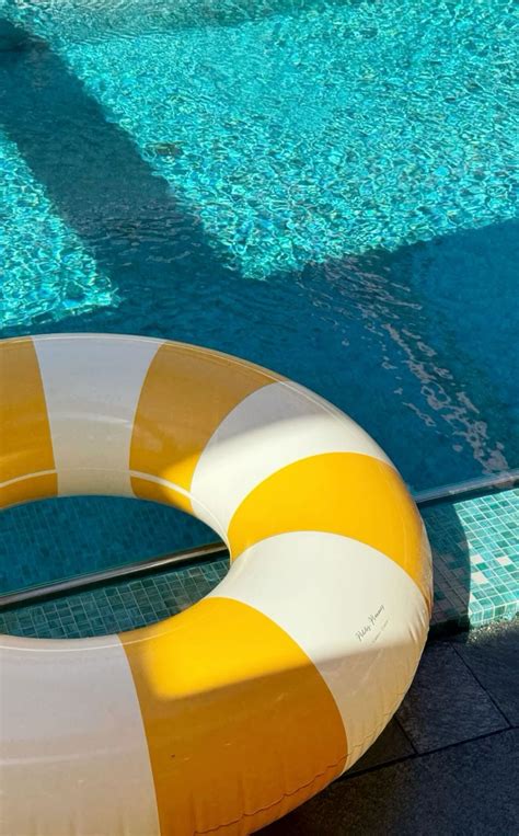 Orange and White Life Preserver by the Pool