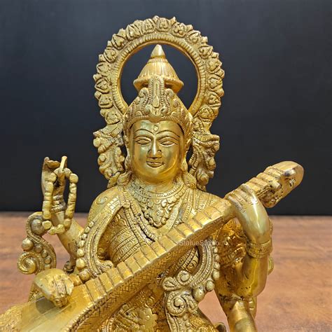 Brass Goddess Saraswati Idol Sitting On Lotus Base 1 Feet – StatueStudio