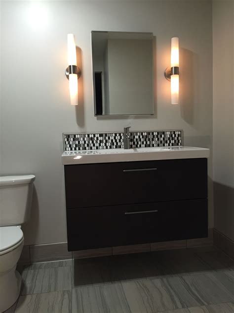 Floating vanity with mosaic tile backsplash. Still thinking about the ...