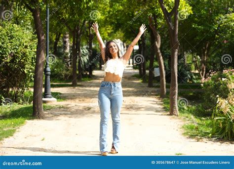 Beautiful Spanish Brunette Woman with Long Curly Hair Raises Her Arms ...