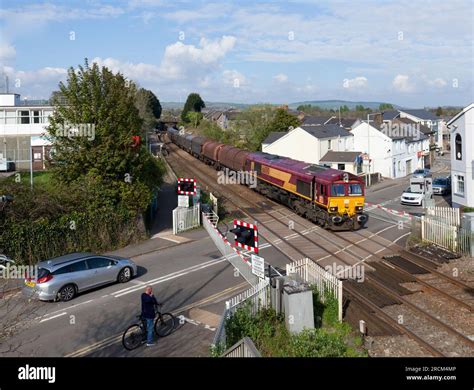 DB Cargo rail UK class 66 locomotive 66080 crossing the level crossing ...