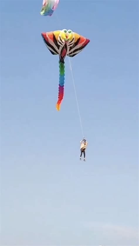 People Flying Kites On The Beach