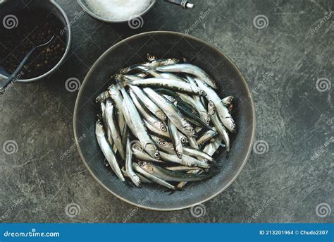 Fresh Raw Anchovies with Sea Salt and Pepper Ready for Salting. Stock ...